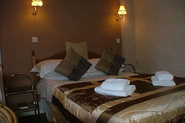Double room interior, brown and gold bedding